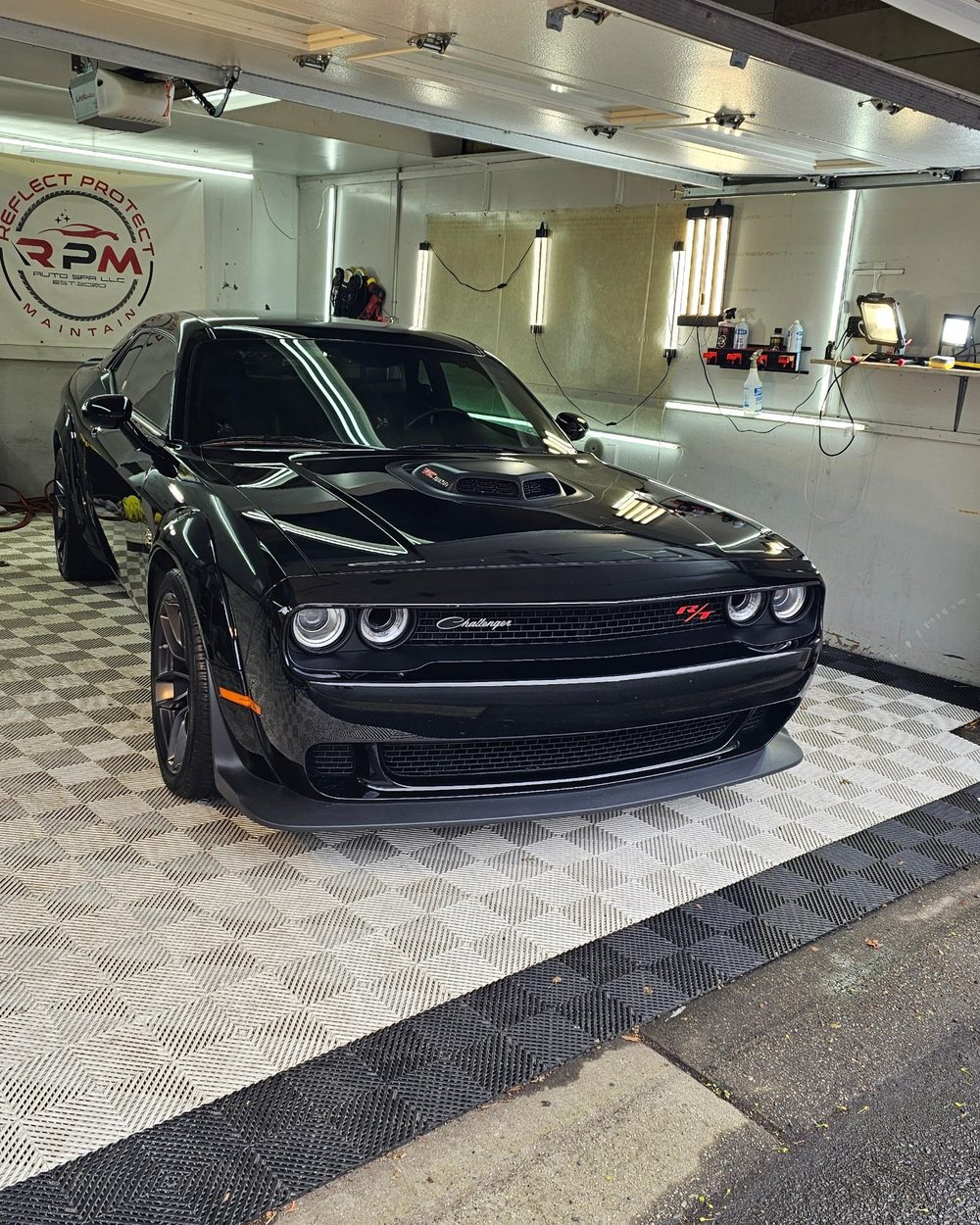 Black Dodge Challenger R/T in the detailing bay